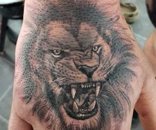 lion hand roaring tattoo realism black grey ancoats manchester